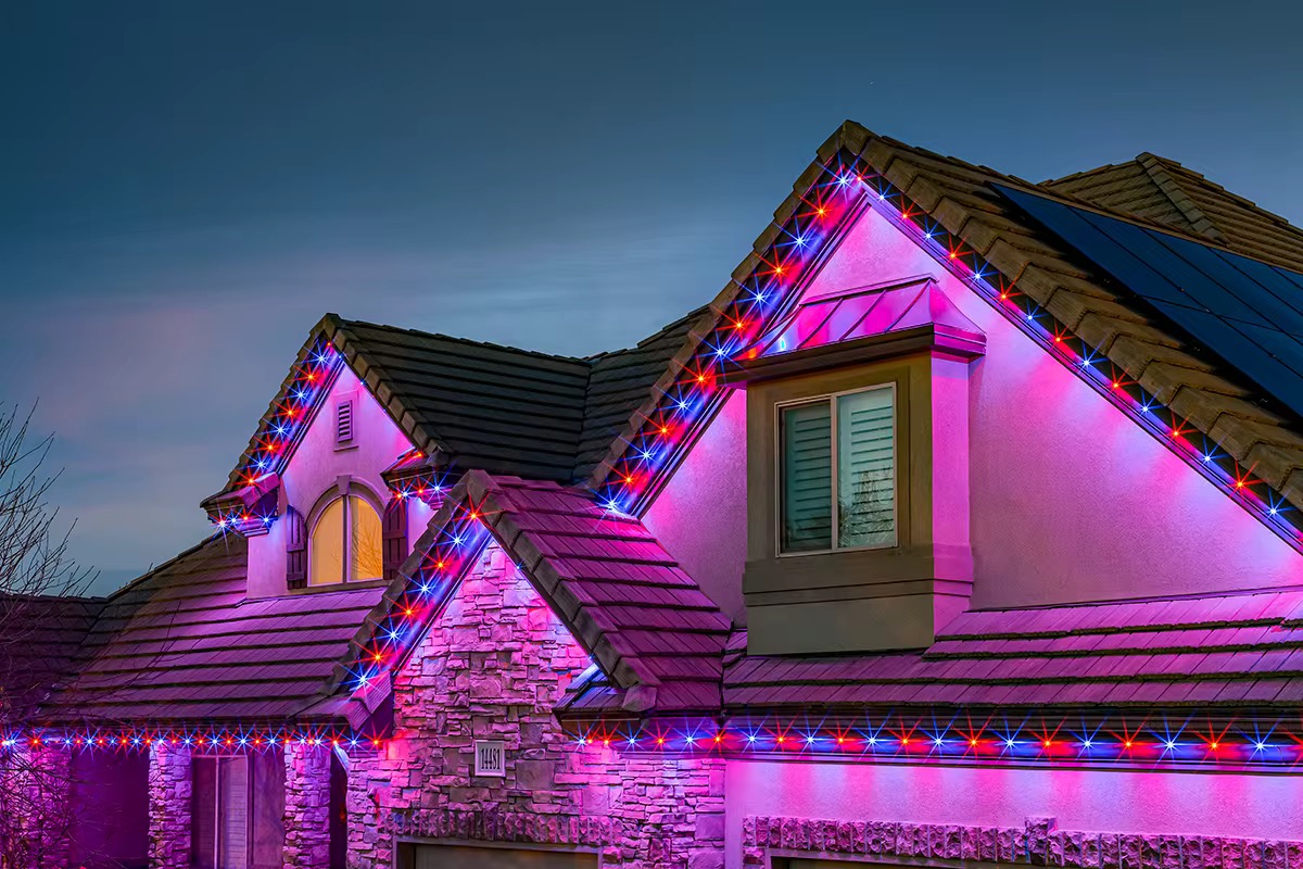 Lit rooflines climbing to several gable peaks.