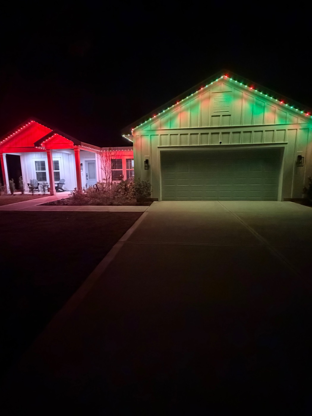 The same home lit red and green for Christmas.