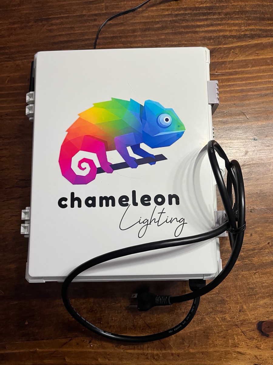 The white Chameleon controller box with its power cord.