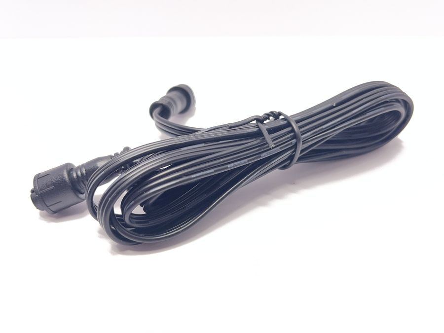A coiled 3 foot black flat wire with a waterproof connector on each end.