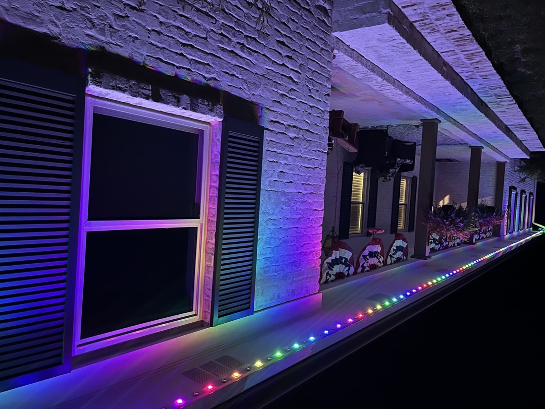 A straight run of puck lights along a single-story eave.