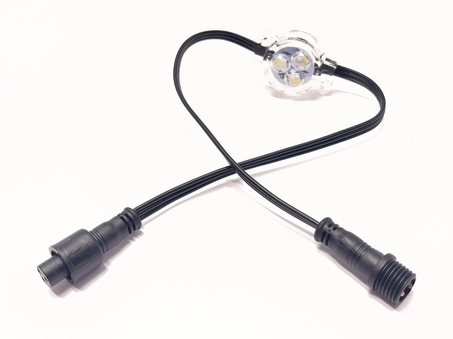 A single RGBW puck light with a connector on each end of its cable.