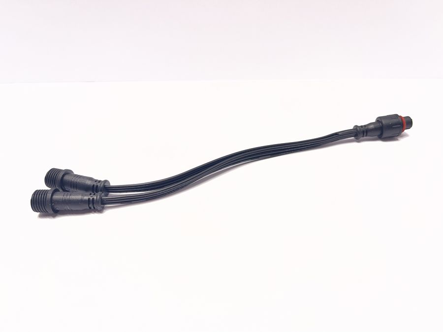 A power-injection tee: one female 3-pin end on the right, and a male 3-pin and a male 2-pin end on the left.